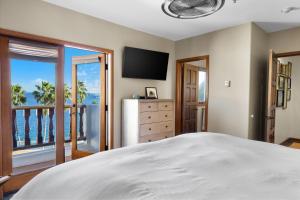 a bedroom with a bed and a view of the ocean at H228 - Hamilton Cove Villa 2-28 in Avalon