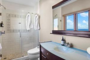 a bathroom with a sink and a toilet and a shower at H228 - Hamilton Cove Villa 2-28 in Avalon +15 photos