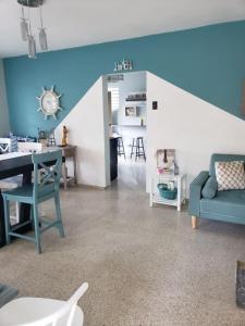 a living room with a blue and white wall at Kassa Wista Azzul Rentals-with pool in Hormigueros