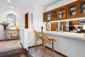 a kitchen with two chairs and a counter at H228 - Hamilton Cove Villa 2-28 in Avalon