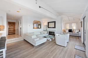 a living room with white furniture and a fireplace at H242 - Hamilton Cove Villa 2-42 in Avalon