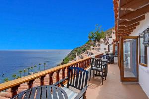 a balcony with chairs and a view of the ocean at H246 - Hamilton Cove Villa 2-46 in Avalon