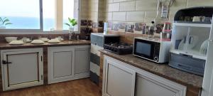 a kitchen with a counter with a stove and a microwave at Etablissement Lina in Afir +18 photos