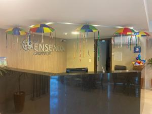 a lobby with umbrellas hanging above a counter at Hotel Enseada Aeroporto in Recife