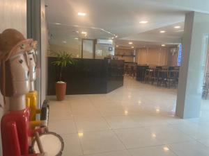 a view of a lobby with a bar and chairs at Hotel Enseada Aeroporto in Recife +26 photos