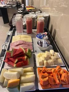 a tray of different types of food on a table at Hotel Enseada Aeroporto in Recife