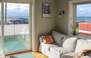 a living room with a couch and a view of the ocean at 5 Bedroom Nice Home In Borhaug in Borhaug