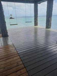 a porch swing with a view of the ocean at 3 Rocks private island in Punta Laurel