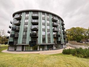 a large apartment building with a green at Ballare Druskininkai in Druskininkai