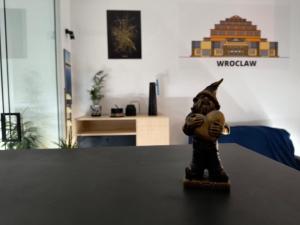 a small figurine on a table in a room at Century Apartment in Wrocław +4 photos