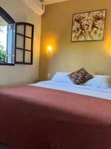 a bedroom with a large bed with a pillow on it at Pousada Belvedere da Serra in Serra do Cipo