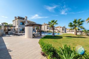 a house with a swimming pool and a patio at Bliss Villas Complex with private pool in Hersonissos