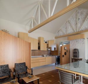 a kitchen and dining room with a glass table and chairs at Belavista Villages in Riba Douro