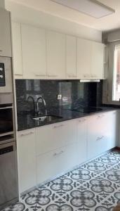 a kitchen with white cabinets and a sink at Apartamento nuevo en Zona Baja de Cotolino in Castro-Urdiales +20 photos
