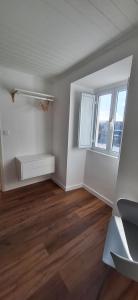 an empty living room with white walls and wood floors at Refúgio das Marés in Ponta Delgada +15 photos
