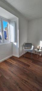 an empty room with a chair and a table at Refúgio das Marés in Ponta Delgada
