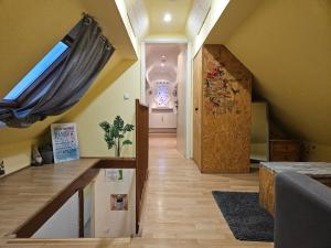 an attic room with a hallway with a window and a door at Ferienwohnungen Ober-Mörlen in Ober-Mörlen