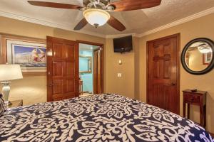 a bedroom with a bed and a ceiling fan at H249 - Hamilton Cove Villa 2-49 in Avalon +15 photos