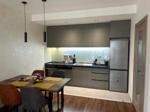 a kitchen with a table and a dining room at Urban Apartment Master Quart in Podgorica
