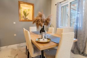 a dining room with a wooden table and chairs at Luxury Getaway with Jacuzzi - Platanos House Salakos in Sálakos