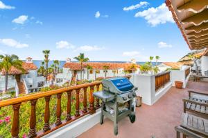 a grill on a balcony with the ocean in the background at H412 - Hamilton Cove Villa 4-12 in Avalon