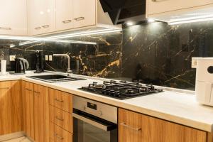 a kitchen with a stove and a counter top at Luxury Getaway with Jacuzzi - Platanos House Salakos in Sálakos