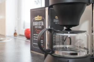 a coffee pot sitting on a counter next to a box at Ferienwohnung Sauerland Winterberg mit Traumhaftem Blick ins Tal in Winterberg +11 photos