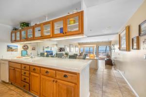 a kitchen with a sink and a living room at H887 - Hamilton Cove Villa 8-87 in Avalon