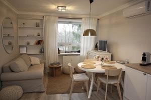 a small living room with a table and a couch at Apartament w Sosnowym SPA in Serock
