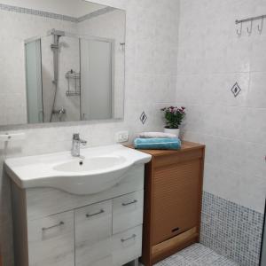 a bathroom with a sink and a mirror at Casa vacanze Colle della Minerva in Otranto +18 photos