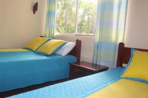 Postel nebo postele na pokoji v ubytování Sacha Tinku