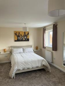a bedroom with a white bed and a window at Flat At 34 in Street
