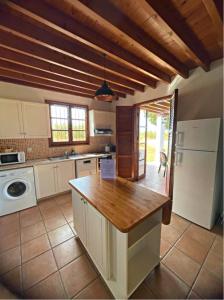 a kitchen with a white refrigerator and a counter top at Ferienhaus In Polis Chrysochous Mit Offenem Kamin in Polis Chrysochous