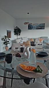a living room with a glass table with a vase at Vineyard-Suites Traumferienwohnung mit Panoramablick und Weinidylle in Elsenfeld +25 photos