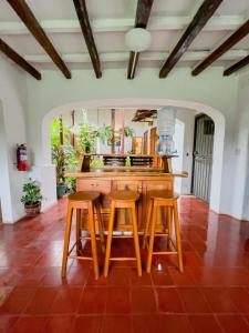 a kitchen with a table and two stools at Casa Dardanelo in Granada