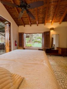 a bedroom with a large bed with a ceiling fan at Casa Dardanelo in Granada +28 photos