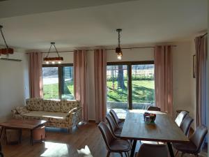 a living room with a table and a couch at La Casa Sofija in Nemenikuće