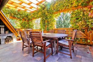 a wooden table and chairs on a patio at House Grga in Gornja Voća