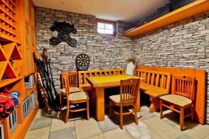 a dining room with a wooden table and chairs at House Grga in Gornja Voća