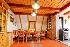 a dining room with a table and chairs and a stove at House Grga in Gornja Voća