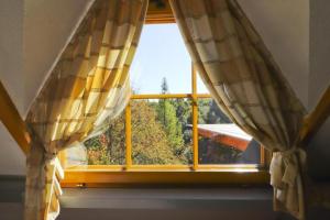 an open window with curtains in a room at House Grga in Gornja Voća +33 photos