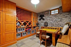 a dining room with a wooden table and chairs at House Grga in Gornja Voća