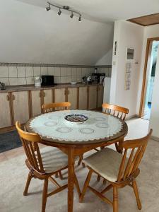 a dining room table and chairs in a kitchen at Kuća za odmor Rosa in Tomislavgrad +12 photos