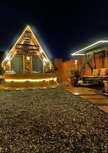 a house with a lit up front yard at night at Baku Garden Aframe - Bungalov in Baku