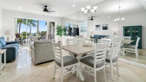 a dining room and living room with a table and chairs at 412 Mariners Club in Key Largo