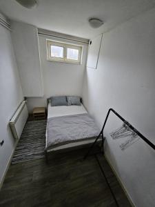 a small room with a bed and a window at Apartman Green Hill in Zagreb