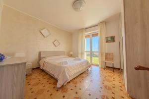 a bedroom with a bed and a large window at Villa Maddalena in Scala