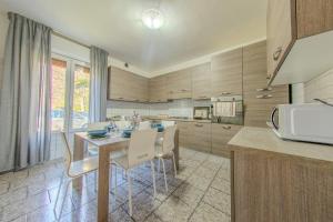 a kitchen with a table and chairs in a kitchen at Villa Maddalena in Scala