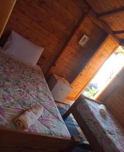 una camera da letto con un letto in una stanza di legno di Guesthouse Rusto a Gjirokastër Altre 13 foto