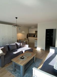 a living room with a couch and a coffee table at Apartament Promyk in Świnoujście